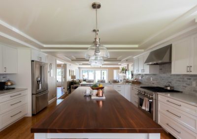 kitchen with wooden island countertop designed by Cutting Edge Design